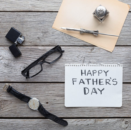 Items on a Wooden Table for Fathers Day Celebration With Gifts and a Cardの写真素材
