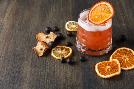 Refreshing Drink With Dried Citrus and Apple Slices on Wooden Table