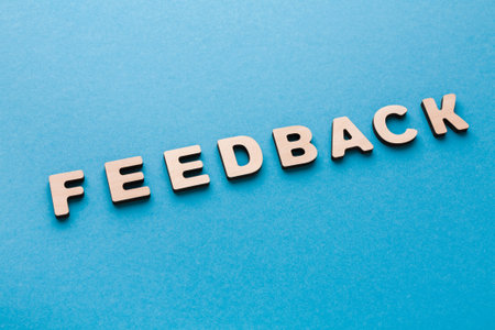 Letters Spelling Feedback Arranged on a Blue Background for Clear View and Understandingの写真素材