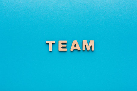 Team Letters Arranged on a Blue Background for Teamwork and Collaboration Conceptsの写真素材