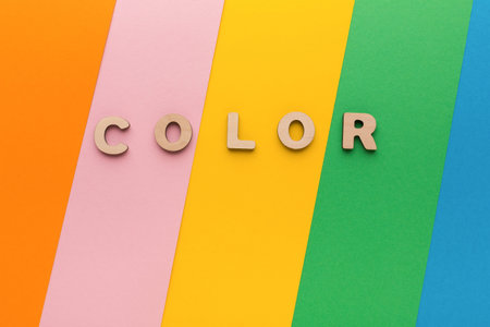 Understanding Color Through Simple Wooden Letters on Colored Paper Stripes in a Flat Layoutの写真素材