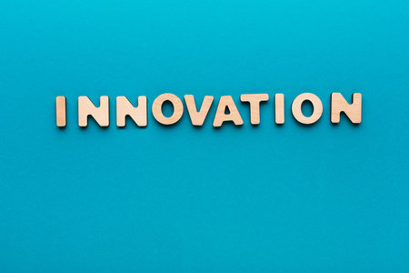 Wooden Letters Spell Innovation on a Blue Background in This Creative Design Concept