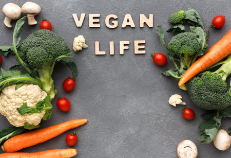 Fresh Vegetables and the Words Vegan Life Are Arranged on a Gray Background at a Kitchen Settingの写真素材