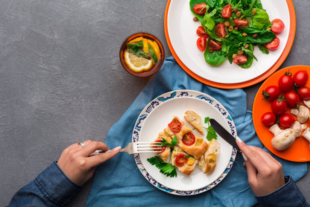 Person Enjoys a Meal of Salad and Pastry With a Drink at a Table Setting With Fresh Ingredients