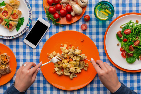 Enjoying a Meal With a Variety of Dishes on a Checkered Tablecloth