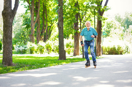 Man Skating on a Path in a Park During a Sunny Day in Warm Weather