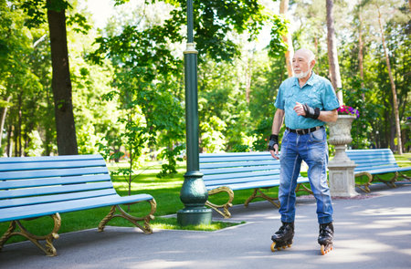 Older Man Skating in a Park on a Sunny Day Near Benches and Trees