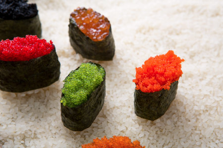 Different Types of Sushi With Various Toppings Arranged on White Riceの写真素材