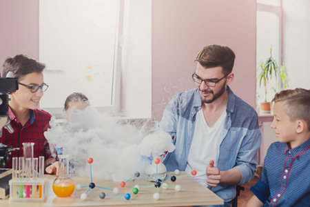 Kids Learn Science in Classroom With Experiments During Practical Session With Teacher