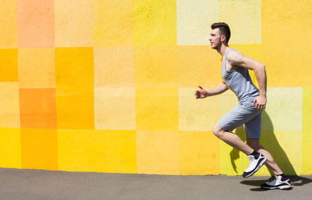 Man Runs Along Colorful Wall During Bright Day in Urban Area