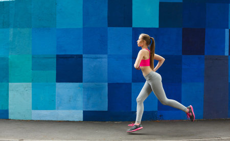 Running in Front of Colorful Wall During the Day in a City Street