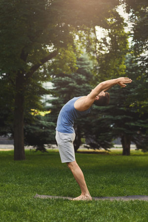 Yoga Practice in the Park During the Evening With a Focus on Stretching and Balance