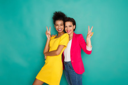 Collage of Two Women Posing Together in Colorful Outfits Against a Bright Background