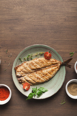 Grilled Fish Served on a Plate With Spices and Herbs in a Kitchen Setting With Wooden Table