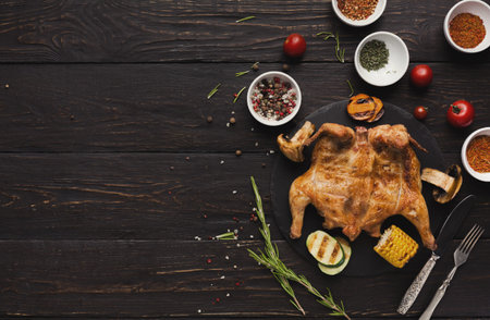Grilled Chicken Served With Herbs, Vegetables, and Spices on Wooden Table