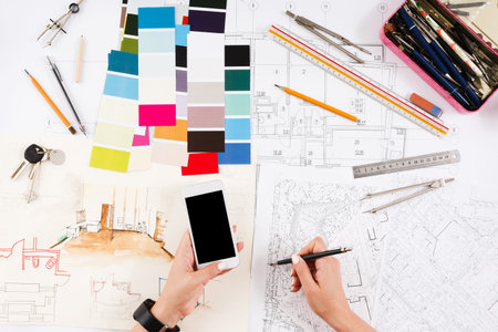 Collection of Design Tools and Sketches on a Table for Planning a Creative Project