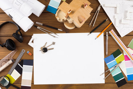 Collection of Tools and Materials Used for Architectural Design and Model Making on a Workspace
