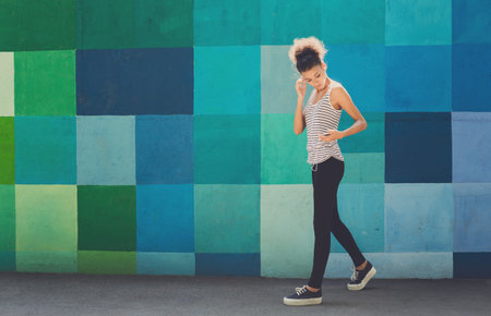 Walking by a Colorful Wall With Square Patterns in a Bright and Lively Outdoor Space
