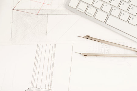 Collage of Architectural Plans and Drawing Tools on a Workspace With a Keyboard in View