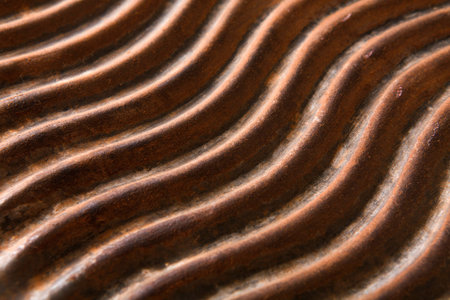Details of a Metal Surface With Grooves in a Wavy Pattern During Bright Light Conditionsの写真素材