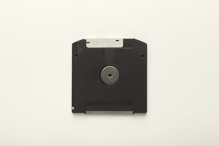 Collection of Old Floppy Disks Arranged in a Mosaic on a Plain Background