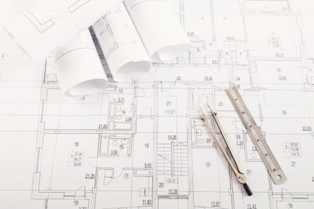 Blueprint Collection Featuring Detailed Architectural Plans and Drafting Tools on a Table