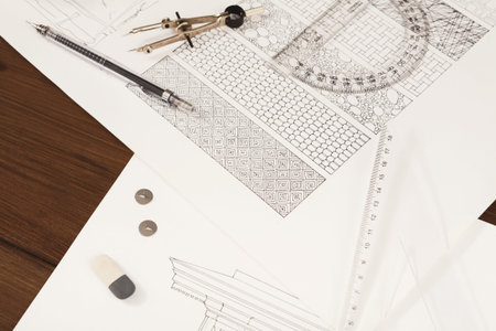 Collage of Design Sketches and Tools for Architectural Projects on a Wooden Table