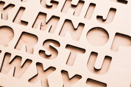 Wooden Alphabet Letters Cut From a Sheet Showcasing Fine Detail During Crafting Process