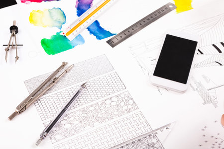 Creative Collage of Design Tools and Colorful Art Materials on a Table in a Studio Setting