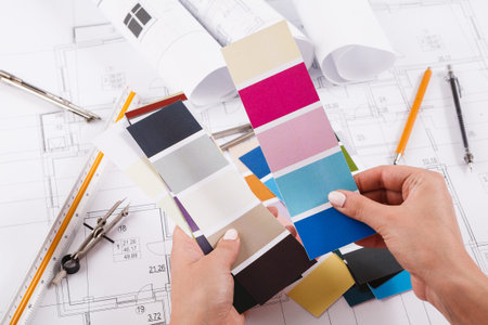 Color Selection for Interior Design Project Involving Plans and Samples on a Workspace Table