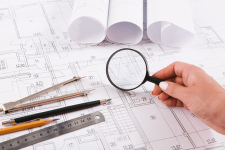 Collection of Tools and Blueprints for a Construction Project on a Work Table
