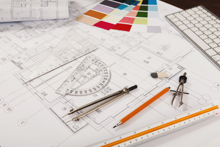 Collection of Architectural Tools and Plans on a Work Desk for Design and Planning Activities