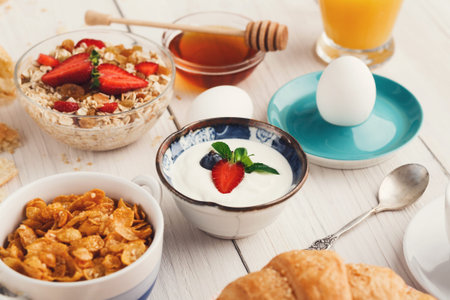Breakfast Collection Shows Various Foods and Drinks on a Wooden Table With a Casual Setting