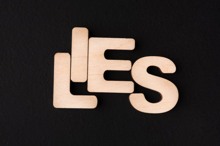 Wooden Letters Forming Words on a Black Surface During a Creative Activity in a Studioの写真素材