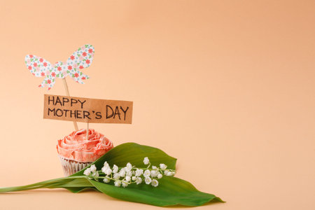 Celebrate Mothers Day With a Cupcake and Flower Decoration on a Simple Background
