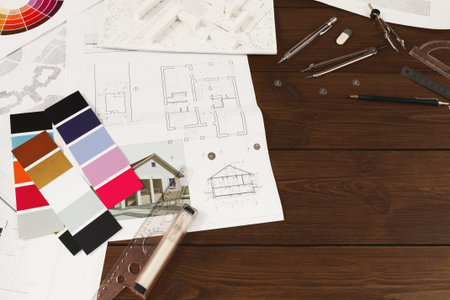 Set of Design Materials and Plans for a Construction Project on a Wooden Table