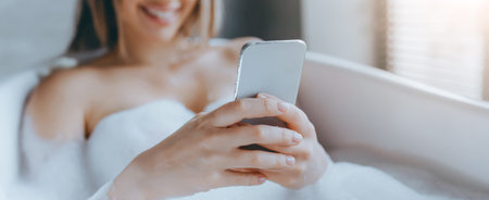 Woman Relaxing in Bathtub While Using Smartphone During Daytime