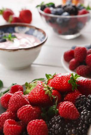 Fresh Berries and Yogurt Spread on a Table in a Bright Setting During the Day