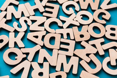 Wooden Letters Scattered on a Blue Surface in a Fun and Playful Arrangement
