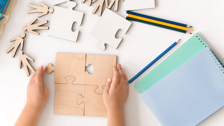 Children Engage in Puzzle Activity With Wooden Pieces and Colored Pencils at a Table