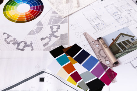 Collage of Design Plans, Color Swatches, and Architectural Sketches on a Workspace Table