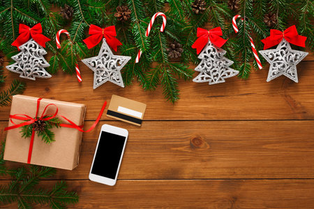 Collage of Christmas Decorations With Gifts and a Smartphone on a Wooden Table in Festive Setting