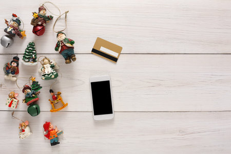 Collage of Holiday Decorations and a Mobile Phone on a Wooden Surface During the Festive Season