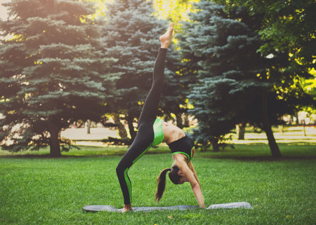 Yoga Practice in Natural Setting With a Person Performing a Handstand Pose