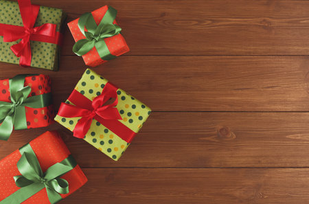 Collection of Wrapped Gifts Arranged on a Wooden Surface With Festive Colors and Bows