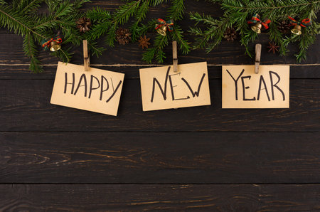 Collection of Cards Displaying Happy New Year Message on a Wooden Background With Green Decor