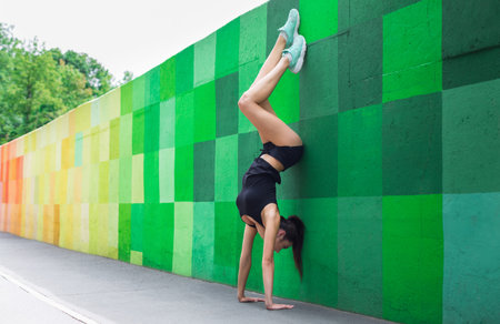 Handstand on a Colorful Wall in a City Park During Daylight Hours