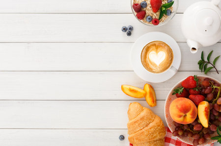 Tasty Breakfast Spread With Coffee, Fruits, and Pastries on a Wooden Table Settingの写真素材