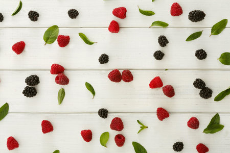 Collection of Berries and Leaves Arranged on a Wooden Surface for a Mosaic Design
