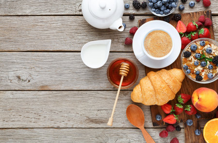 Delicious Breakfast Set Showing a Collection of Food and Drink Items on a Wooden Table